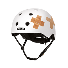 Load image into Gallery viewer, Melon Helmets white helmet with printed bandages designed for skateboarding, biking, scooter, and commuting
